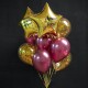 Фонтан из бордовых и прозрачных шаров с конфетти со звездами