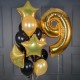 Фонтан из черно-золотых шаров с цифрой 9 на День рождения
